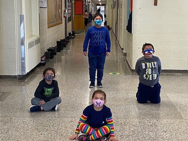 In the photo, students at Holy Family Catholic School in Wallaceburg display some of the donated face masks imprinted with Indigenous art work.