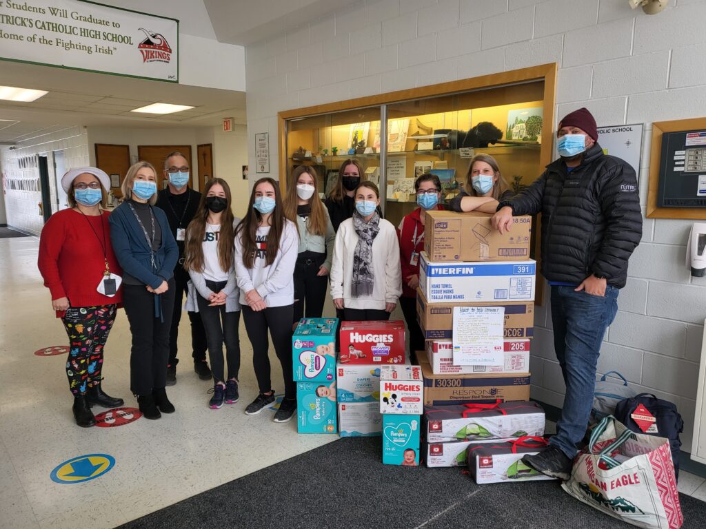 Members of the St. Philip Catholic School community pose with some of the many items collected for shipment to the Ukraine.