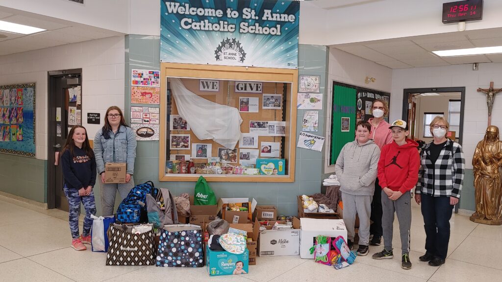 In the photo with students at St. Anne Catholic School in Blenheim are (far right) Mary Dunlop and Cindy Waddick of Canadian Food for Children – Chatham-Kent.