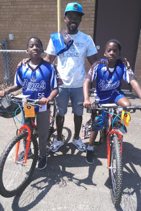 Two students who received new bicycles in the Dress Down for Wheels event are new to Canada.  Elando (left) and Elonzo Rhoden are pictured with dad Elton Rhoden (centre) and their brand new bikes!