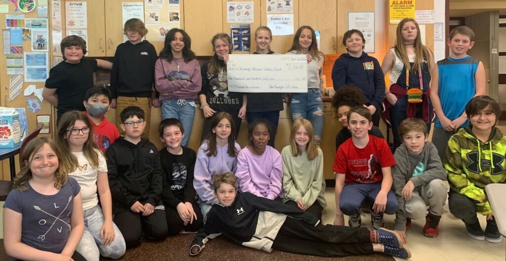 Students in the Grade 5/6 class at St. Matthew Catholic School with a cheque for $1,166, which they presented to St. George Catholic Ukrainian Church.